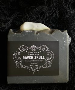 black soap bar with white raven skull embed on top